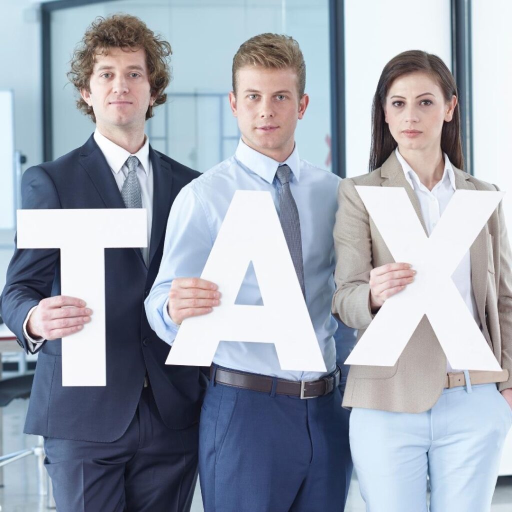 People holding tax text