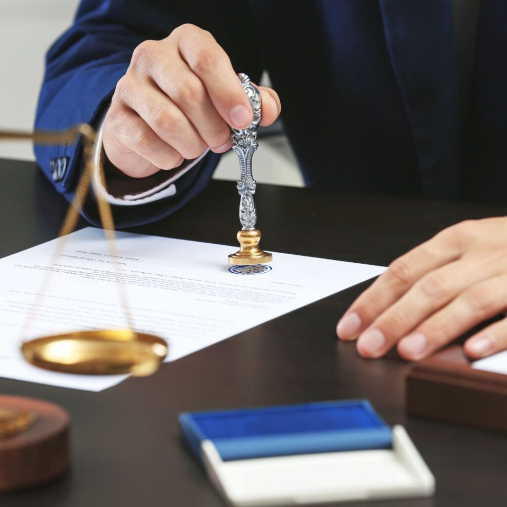 notary stamping a document with a wax seal
